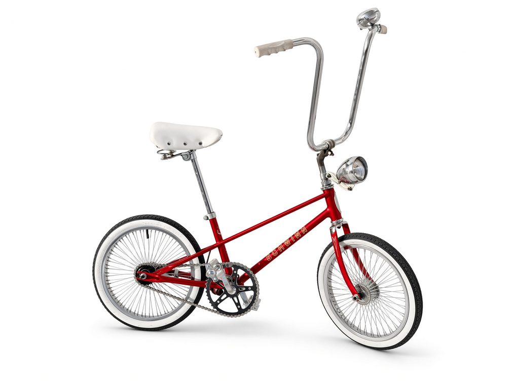 Candy red 16 inch pit conversion with tall bars and headlight, real bike photographed on a plain background